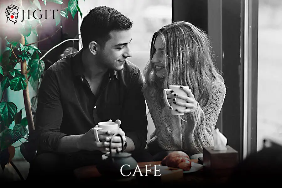 Rent-a-boy and a girl drinking coffee in a street cafe jigit-uz